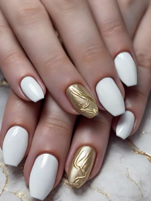 A woman's hand with white and gold nails.