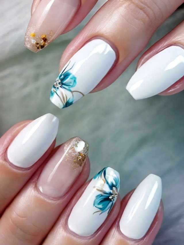 A woman with white and blue nails with flowers on them.