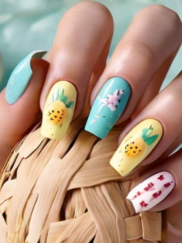 A woman's nails are decorated with cute pineapples and flowers, creating a delightful Easter-themed design.